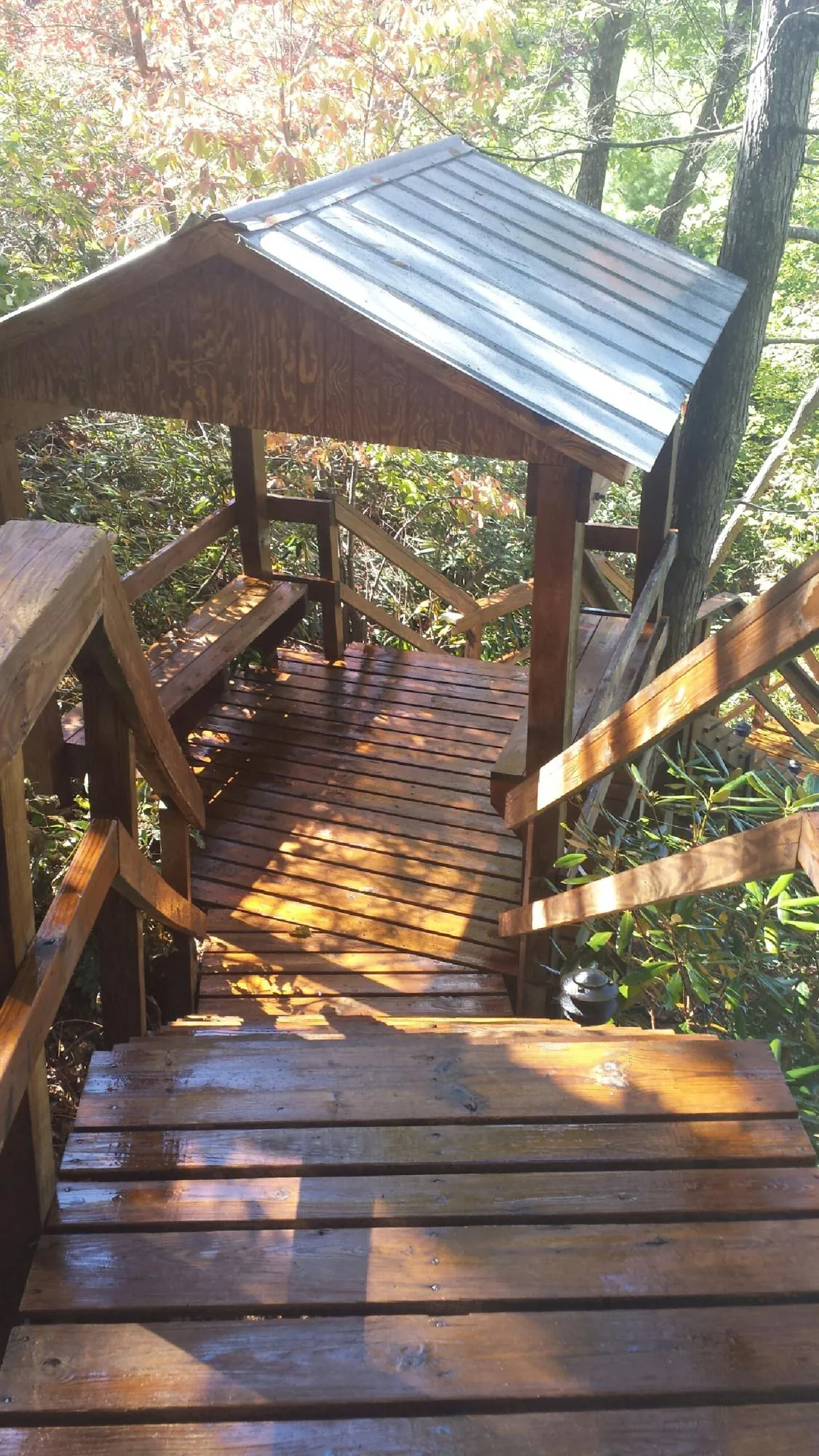 Freshly stained wood walkway and covered shelter with a metal roof in Dayton